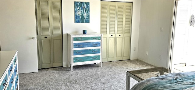 carpeted bedroom with multiple closets