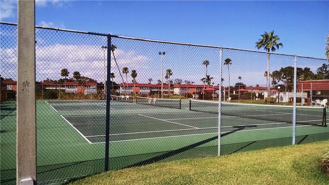 view of sport court featuring fence