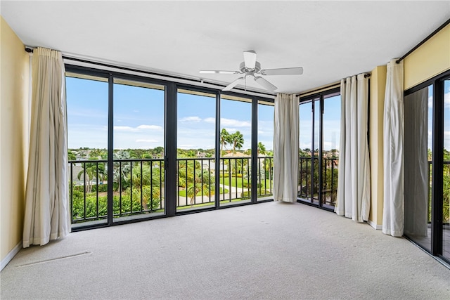 unfurnished sunroom featuring a healthy amount of sunlight and ceiling fan