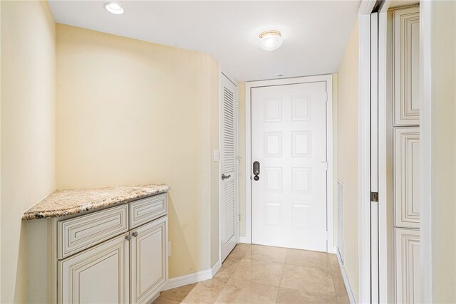 hallway featuring light tile patterned floors