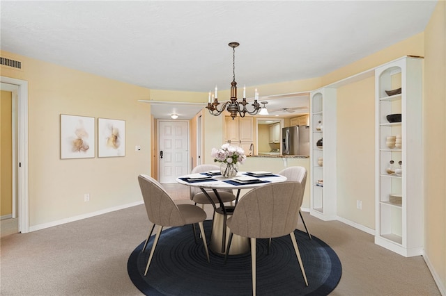 carpeted dining room featuring built in features and a notable chandelier