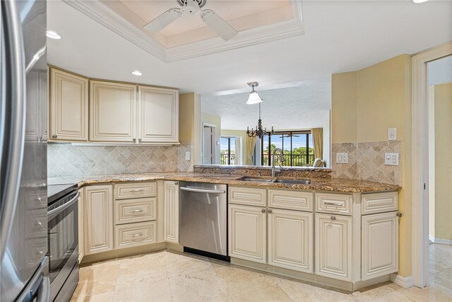 kitchen with decorative backsplash, appliances with stainless steel finishes, sink, and cream cabinets