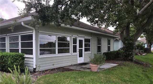 view of side of home with a yard