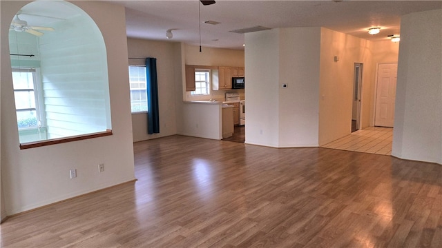 unfurnished living room featuring light hardwood / wood-style floors and ceiling fan