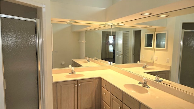 bathroom with vanity and a shower with door