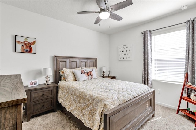 bedroom featuring ceiling fan and light carpet