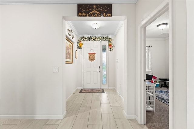 foyer featuring baseboards and ornamental molding