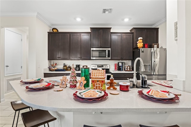 kitchen featuring visible vents, appliances with stainless steel finishes, and a breakfast bar area