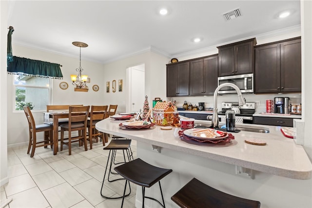 kitchen with visible vents, a breakfast bar, stainless steel microwave, dark brown cabinetry, and crown molding