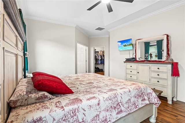 bedroom with visible vents, dark wood-type flooring, ceiling fan, ornamental molding, and a closet