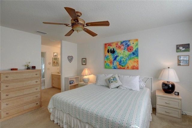 carpeted bedroom featuring ceiling fan and connected bathroom