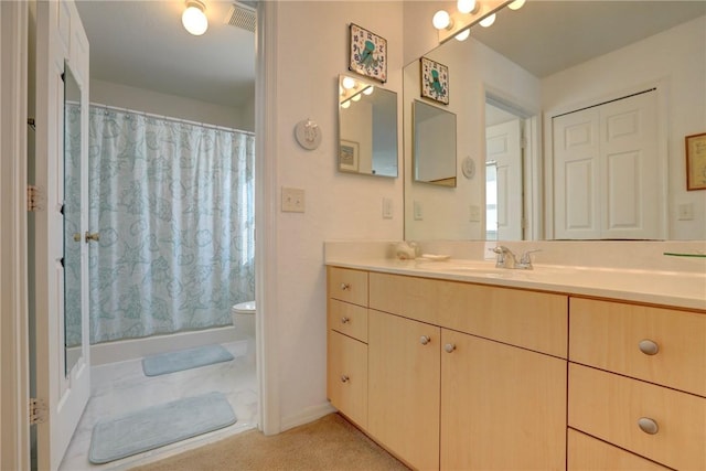 bathroom featuring vanity, curtained shower, and toilet