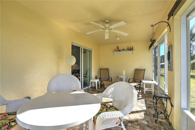 sunroom with plenty of natural light and ceiling fan