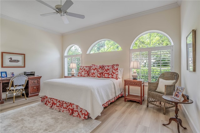 bedroom featuring ceiling fan, ornamental molding, wood finished floors, and baseboards