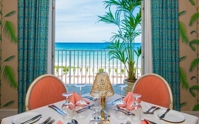 balcony with a water view and a beach view