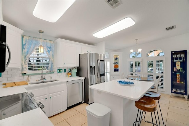 5367 Montego Cir, Hutchinson Island, FL 34949 - kitchen with a sink, stainless steel appliances, light tile patterned floors, and healthy amount of natural light