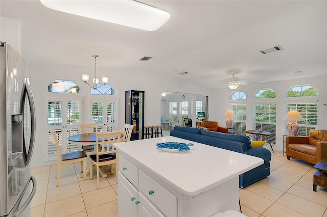 5367 Montego Cir, Hutchinson Island, FL 34949 - kitchen featuring stainless steel fridge, light tile patterned floors, a ceiling fan, lofted ceiling, and open floor plan