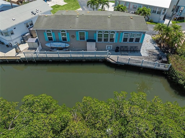 5367 Montego Cir, Hutchinson Island, FL 34949 - back of property featuring a water view, roof with shingles, and a patio area