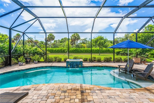 view of swimming pool with pool water feature, a patio, and glass enclosure