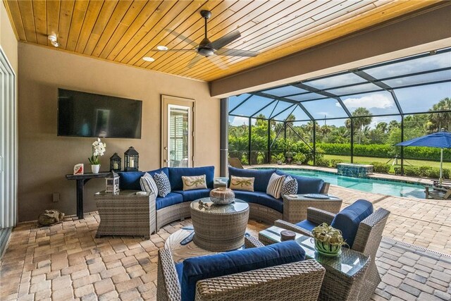 view of patio / terrace with a lanai, outdoor lounge area, and ceiling fan