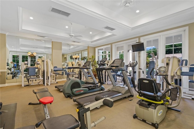 workout area featuring french doors, a raised ceiling, ceiling fan, and crown molding