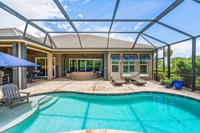 view of pool featuring a lanai, a patio area, ceiling fan, and area for grilling