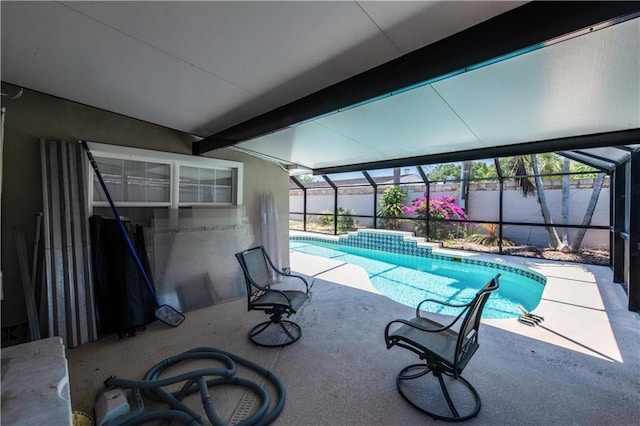 view of swimming pool featuring a lanai and a patio area