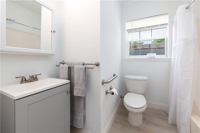 bathroom with hardwood / wood-style flooring, vanity, and toilet