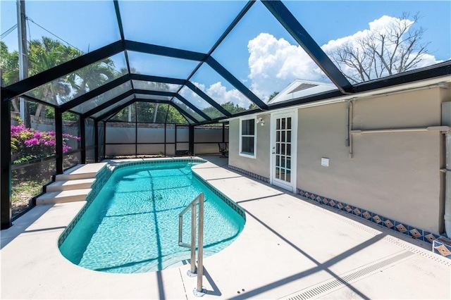 view of swimming pool with a patio area and a lanai