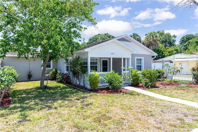 view of front of home featuring covered porch and a front yard