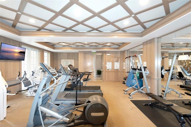 exercise room with wood walls, crown molding, light carpet, and coffered ceiling