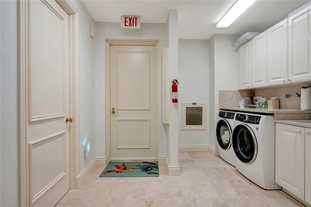 laundry area featuring cabinets and separate washer and dryer