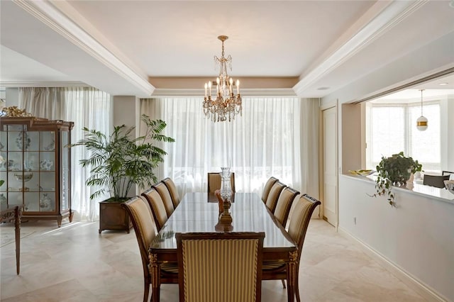 dining room featuring a chandelier, a tray ceiling, plenty of natural light, and ornamental molding