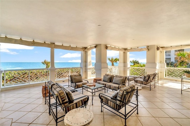 sunroom / solarium featuring a water view and a view of the beach