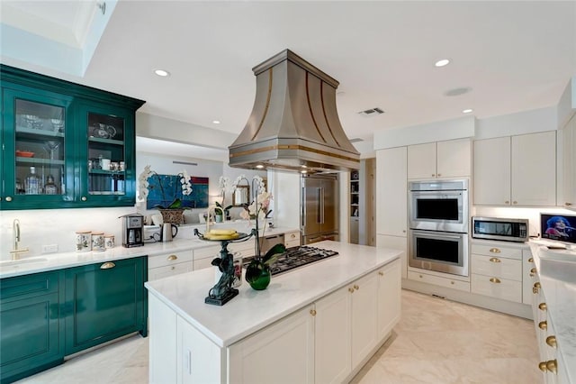 kitchen featuring sink, a kitchen island, appliances with stainless steel finishes, white cabinets, and custom exhaust hood