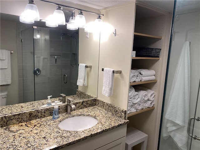 bathroom featuring vanity, toilet, and walk in shower