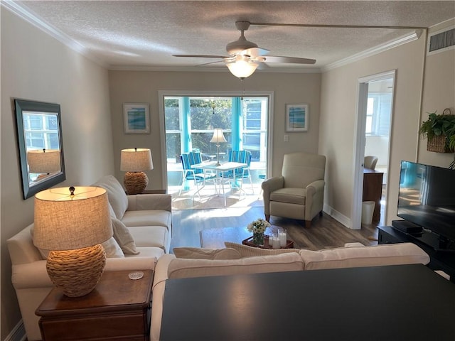 living room featuring a textured ceiling, hardwood / wood-style flooring, ceiling fan, and crown molding