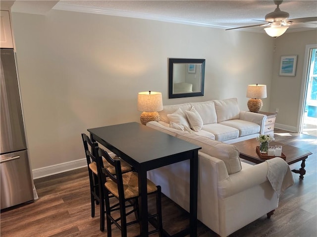 living room featuring ceiling fan, crown molding, and dark hardwood / wood-style floors