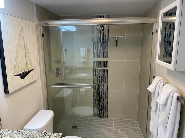 bathroom featuring toilet and walk in shower