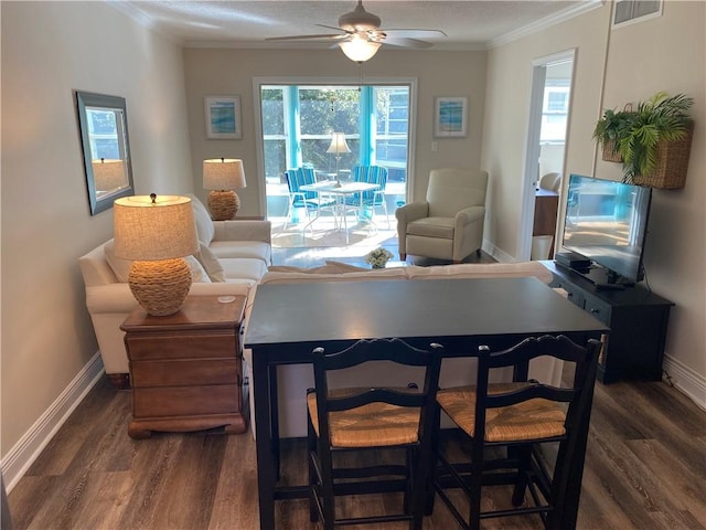 living room featuring a wealth of natural light, ceiling fan, and dark wood-type flooring