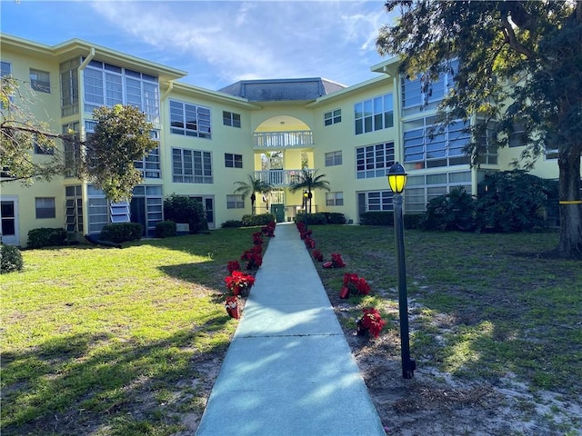 view of home's community with a lawn