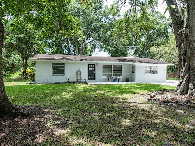 view of front of home featuring a patio area and a front lawn