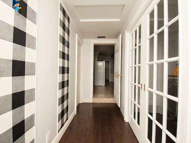 corridor with dark hardwood / wood-style flooring, french doors, and crown molding