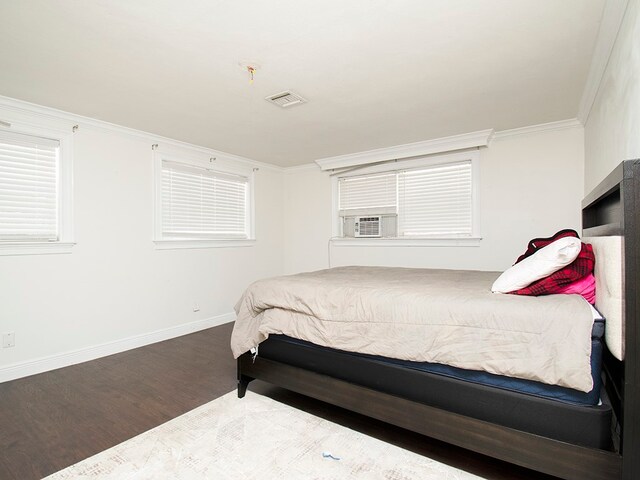 bedroom with hardwood / wood-style floors and ornamental molding