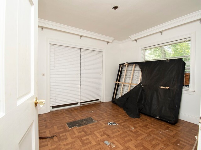 interior space featuring dark parquet flooring and crown molding