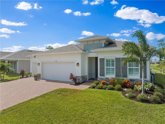 view of front of property featuring a front yard and a garage