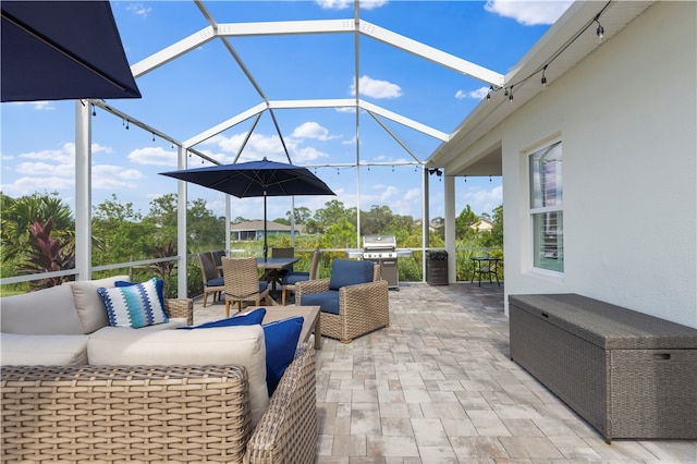 view of patio / terrace featuring grilling area, glass enclosure, and an outdoor living space