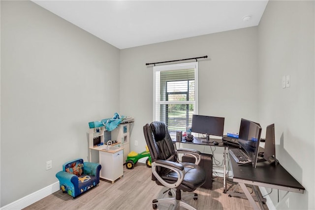 office with light hardwood / wood-style flooring