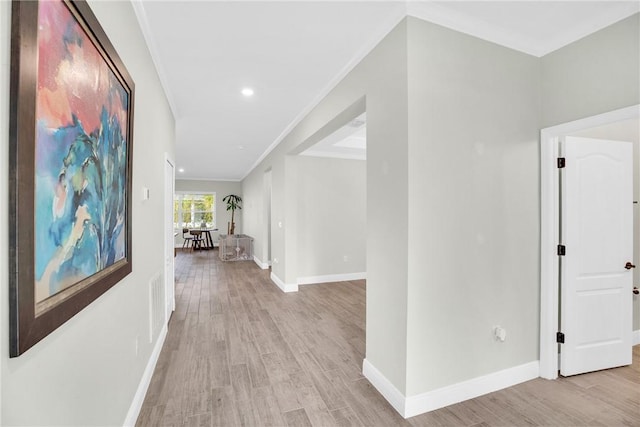 corridor featuring crown molding and light wood-type flooring