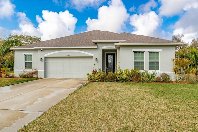 view of front of house featuring a garage and a front yard